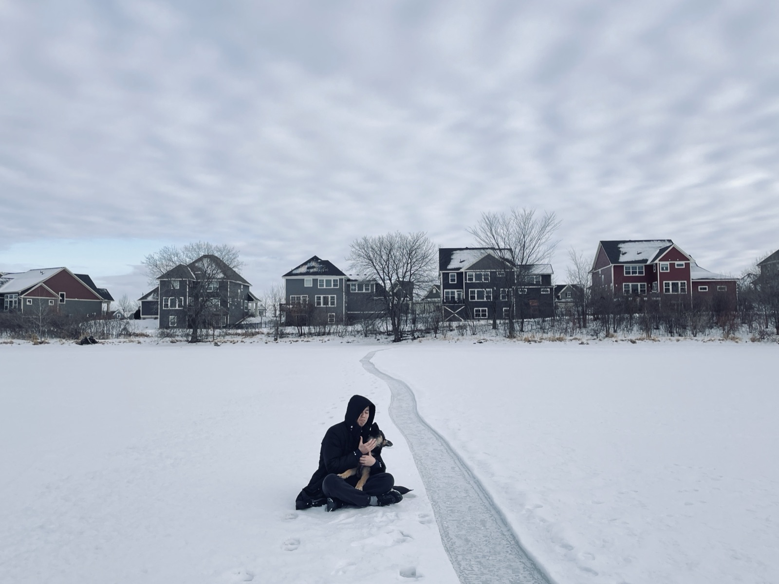 Linkai Li holding Sky by a neighborhood lake in Minnesota