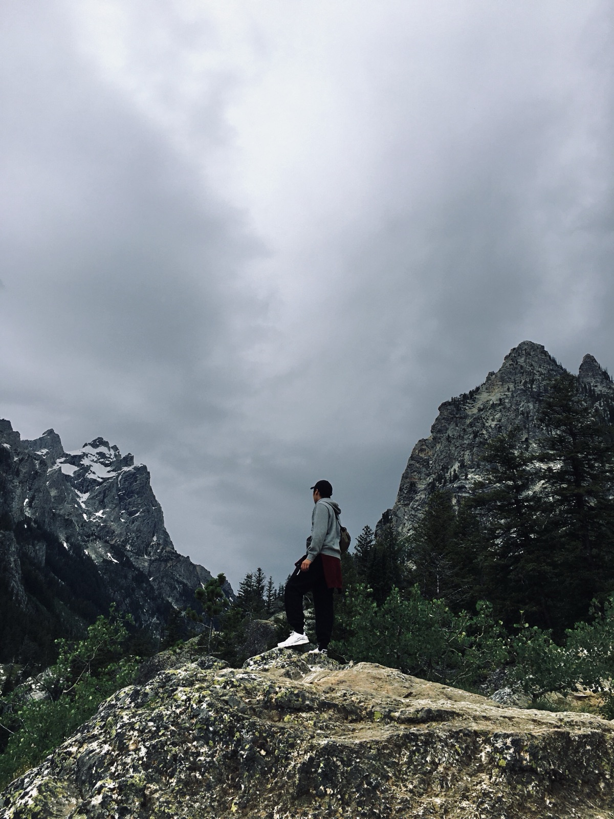 Linkai Li standing above a mountain landscape in Yellowstone National Park